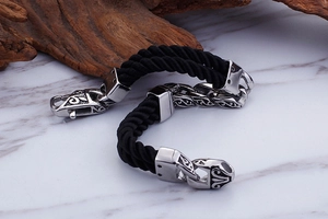 Detailed macro of vintage silver metal buckle on black braided nylon rope bracelet