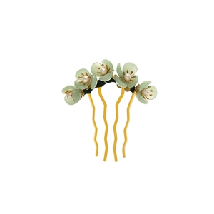 Detail of green floral hair fork with pearls and golden four-prong metal base