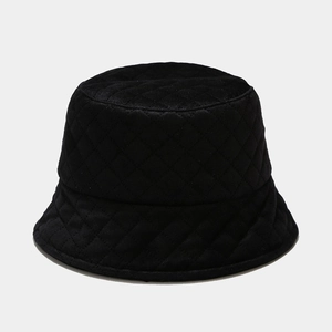 Detailed view of black quilted bucket hat featuring classic diamond stitch patterns
