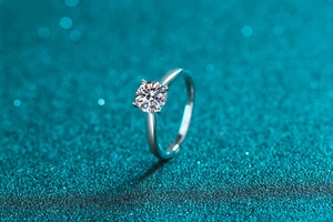 Detailed macro view of a round brilliant cut moissanite diamond set in a silver ring band