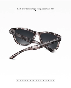 Close-up of black and grey camouflage sunglasses with high-gloss finish and grey lenses