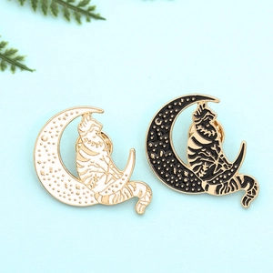 Punk style cat on moon enamel pins set in black and white alloy with gold detailing