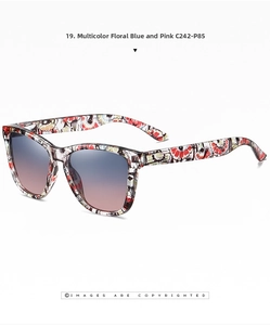 Detail of floral patterned sunglasses frame with blue-pink gradient lenses