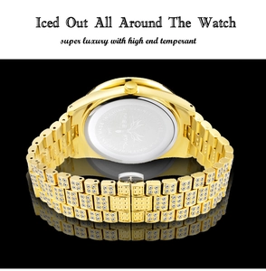 Close-up of gold iced out watch with stainless steel back and luxury crystal setting