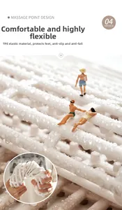 Macro shot of flexible white TPE bath mat showing anti-slip massage bumps and mesh holes
