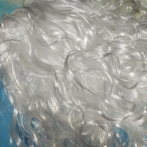 Macro shot of silver-white synthetic wavy fibers for Santa Claus wigs and beard sets