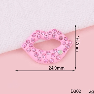 Close-up of pink crystal rhinestone lip accessory with 24.9mm width and 16.7mm height