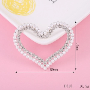 Detail view of heart-shaped pearl and rhinestone charm with 54mm by 69mm dimensions