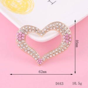 Detailed view of 46mm heart-shaped golden alloy brooch with pink and clear crystals