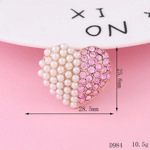 Macro shot of heart-shaped alloy charm with pink rhinestones and pearls, 28.5mm wide
