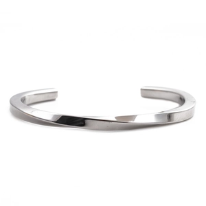 Macro shot of polished silver stainless steel twisted open cuff bracelet on white background