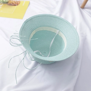 Light blue straw sun hat for girls with white drawstring shown from a top-down view