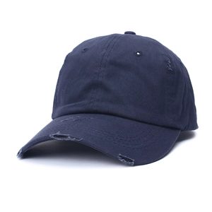 Detailed close-up of distressed navy blue cotton baseball cap with vintage frayed edges