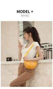 Bright yellow crescent bag featuring crocodile embossed texture and adjustable wide strap