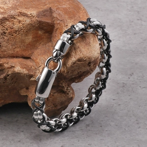 Men's retro punk leather and steel woven bracelet displayed on a natural brown stone
