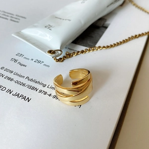 Macro shot of 925 sterling silver gold-plated ring showing multilayer woven texture