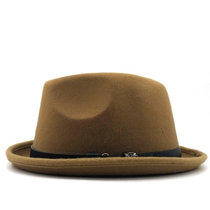Detail of camel wool fedora hat featuring a black leather band and silver flower buckle
