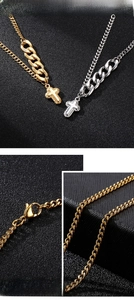 Macro detail of men's stainless steel cross pendant and thick Cuban link chain texture