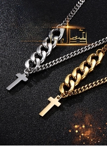 Close-up of gold and silver titanium steel Cuban chain necklaces with polished cross pendants