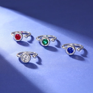 S925 silver moissanite rings in red, green, blue, and white colors on purple background