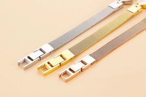 Detailed view of mesh stainless steel watch straps in silver, gold, and rose gold finishes