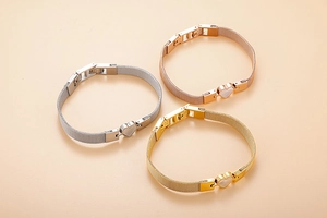 Detail of heart shell bracelets in silver, gold, and rose gold with mesh band