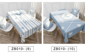 Close-up of Christmas linen tablecloths with reindeer and Santa Claus festive patterns