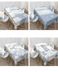 Detail of Christmas themed linen tablecloth with snowflake and reindeer patterns