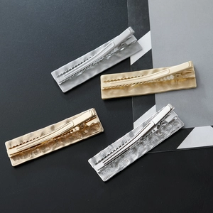 Textured metallic alloy duckbill hair clips in gold and silver finish for women