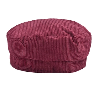 Detailed texture of dark red corduroy fabric on a retro newsboy beret hat for women