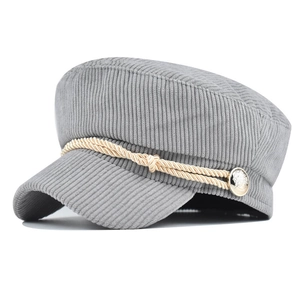 Detail of light gray corduroy newsboy hat with gold rope and vintage metal buttons