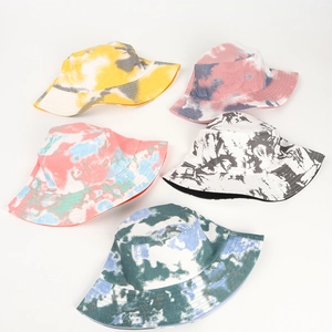Top view of five colorful tie-dye bucket hats in various shades on a white background