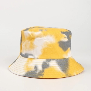 Close-up of tie-dye bucket hat with yellow and grey patterns and reinforced stitching