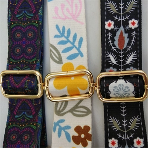 Adjustable crossbody bag straps with floral and ethnic patterns and gold hardware