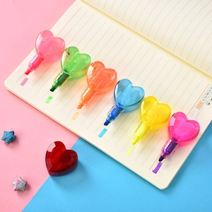 Detail of six heart-shaped highlighters in various colors on an open notebook paper