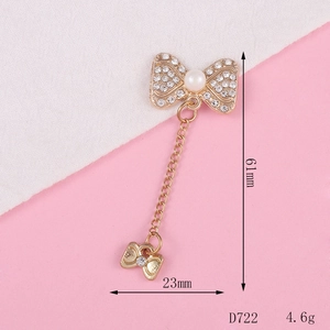 Golden bow pendant with pearls and rhinestones measuring 61mm by 23mm for DIY jewelry