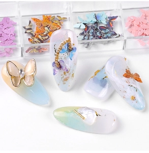 Close-up of vibrant 3D butterfly nail art with gold foil and colorful sequins detail