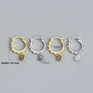 Detail view of S925 sterling silver hoop earrings with sunburst charms and bead accents