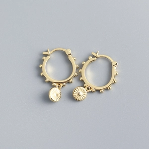 Detailed view of gold S925 sterling silver hoop earrings with bead and disc charms
