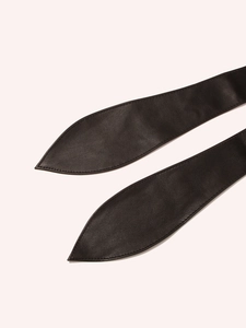 Close-up of black leather wide waist belt showing fine stitching and streamlined pointed tip
