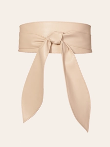 Detail of elegant beige bow knot wide belt in premium faux leather with fine texture