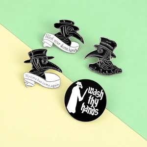 Set of four plague doctor enamel pins featuring black and white raven masks with text