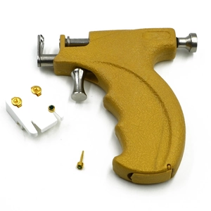 Manual yellow ear piercing gun kit with stainless steel needle and gold stud