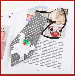 Detail of grey polka dot pet tie with white ghost motif and bow for Halloween costumes