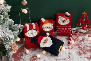 Festive Christmas cotton socks with reindeer and santa patterns on a snowy scene backdrop
