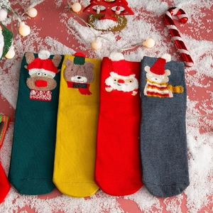 Set of four festive Christmas cotton crew socks with plush cartoon embroidery on a snowy base
