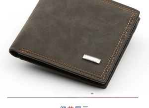 Detail of men's bifold wallet with matte black leather and contrast orange stitching