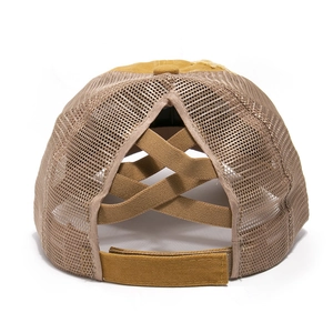 Detail view of mustard yellow ponytail baseball cap with criss-cross elastic bands and mesh