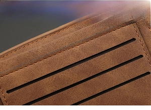 Close-up of brown leather wallet with durable nylon stitching and multiple card slots