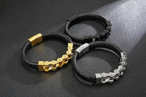 Three men's woven leather bracelets with black, gold and silver bicycle chain links